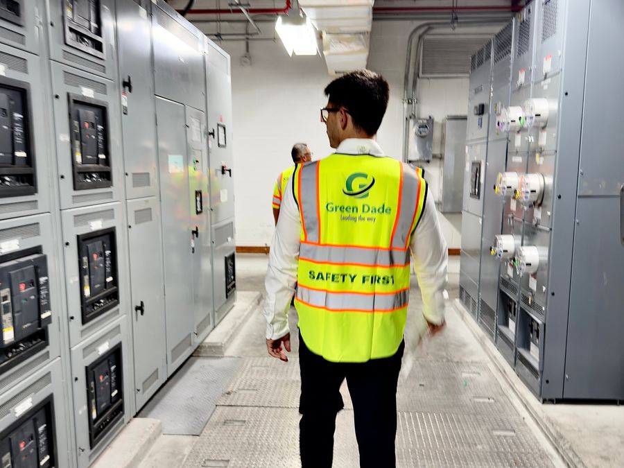 Green Dade engineers walking a switchgear room during a field assessment