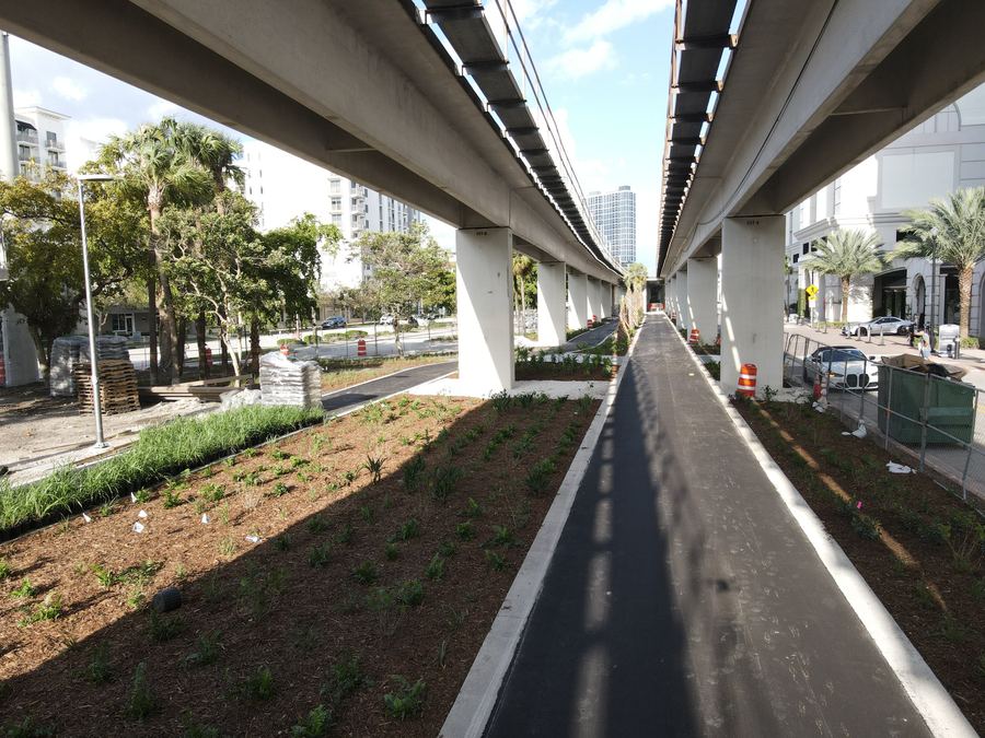 Completed Underline Phase 3 trail beneath the Metrorail guideway, with new trail lighting